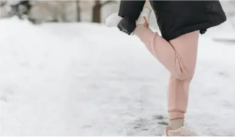 Person stretching in winter snow